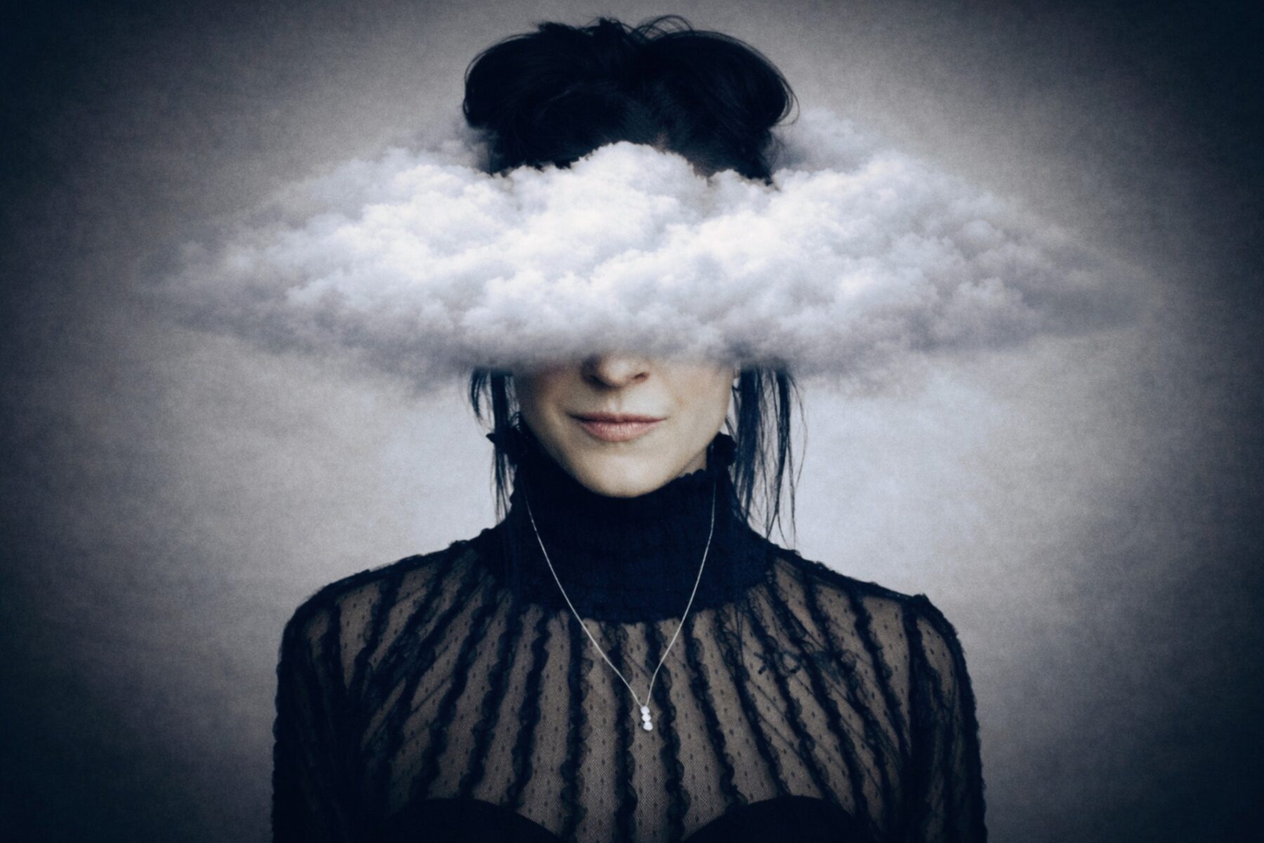 Kelly in an editorial portrait with clouds surrounding her head